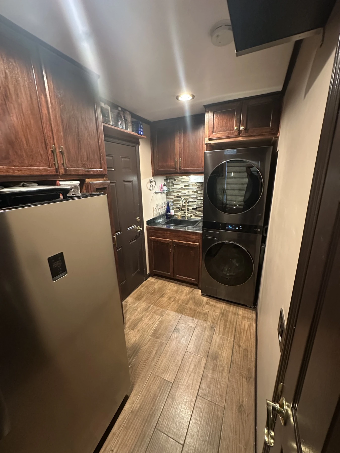 Finished laundry room with utility sink, part of a Mulhearn Plumbing residential project